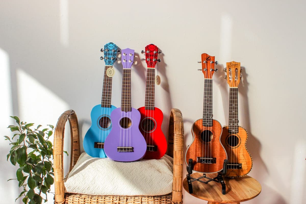 A ukulele lying on a light wooden table